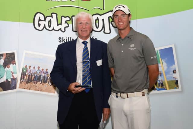 Alistair Tait, left, receives his award from Nicolas Colsaerts. Picture: Getty