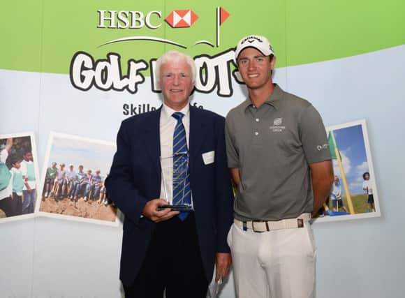 Alistair Tait, left, receives his award from Nicolas Colsaerts. Picture: Getty