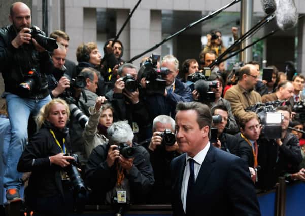 David Cameron walks past the media as he arrives for a summit in Brussels. Picture: Getty