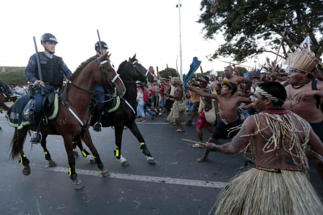 Police confront tribesmen marching towards the Mane Garrincha football stadium. Picture: Reuters
