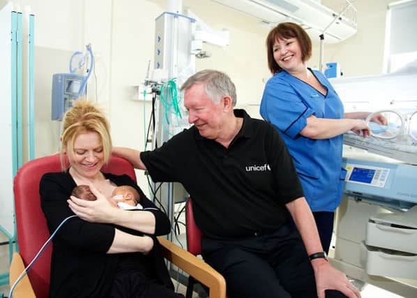 Sir Alex meets new mother Rebecca Young and twin boys Elliot and Sandy. Picture: Jill Jennings