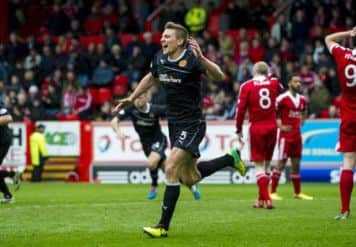 Craig Reid wheels away after snatching second spot for Motherwell. Picture: SNS