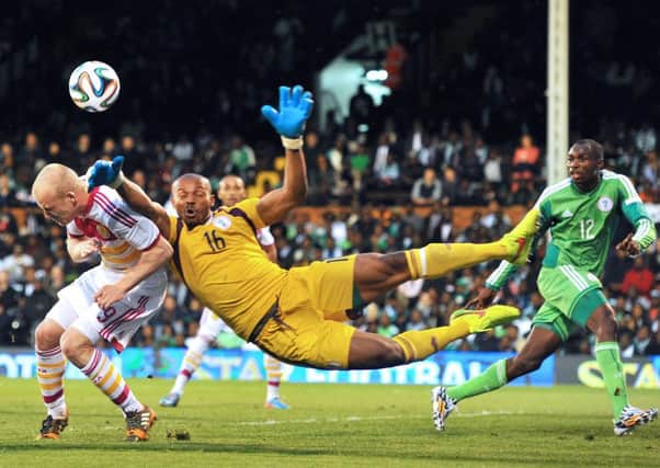 Nigeria goalkeeper Austin Ejide vies with Scotland striker Steven Naismith. Picture: Getty