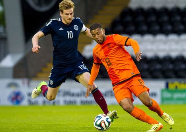 Holland U21s' Tonny Trindade De Vilhena, right, tries to keep possession from Stuart Armstrong. Picture: SNS