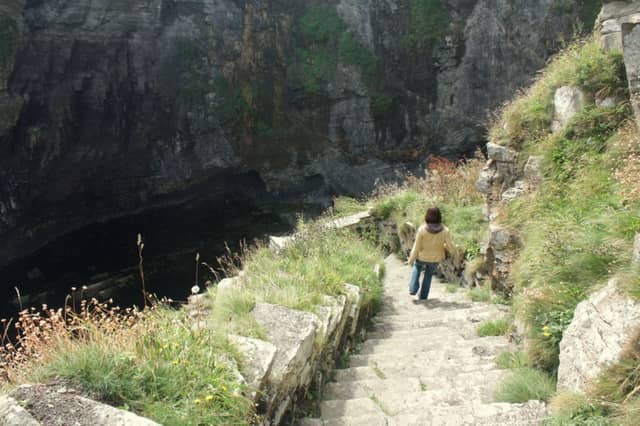 A visitor descends the Whaligoe Steps towards the harbour. Picture: Wiki Commons