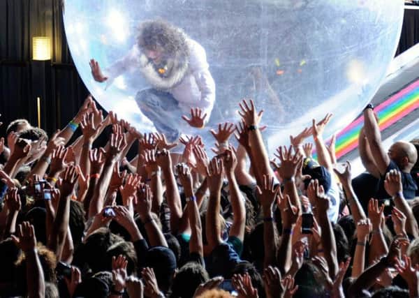 The Flaming Lips frontman Wayne Coyne  in clothes this time  and in crowd-surfing mood. Picture: Getty