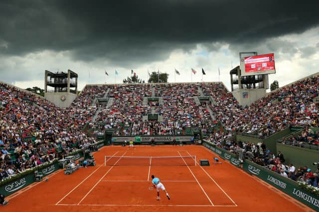 Court Suzanne Lenglen: Novak Djokovic serves during his men's singles match against Marin Cilic. Picture: Getty