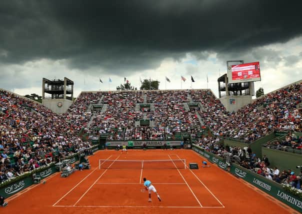 Court Suzanne Lenglen: Novak Djokovic serves during his men's singles match against Marin Cilic. Picture: Getty