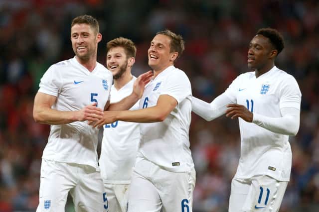 Phil Jagielka (centre) celebrates scoring England's third goal. Picture: PA