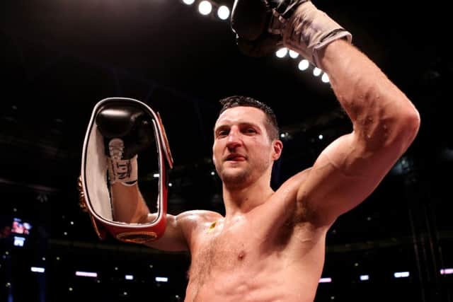 Carl Froch celebrates with his belt after knocking down George Groves. Picture: PA