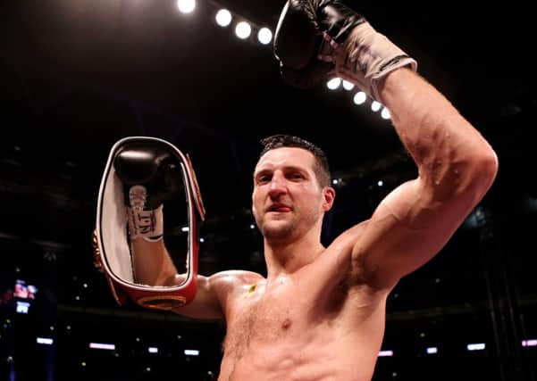 Carl Froch celebrates with his belt after knocking down George Groves. Picture: PA