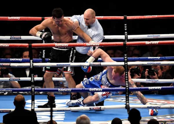 Carl Froch knocks down George Groves during the IBF and WBA World Super Middleweight Title fight. Picture: PA