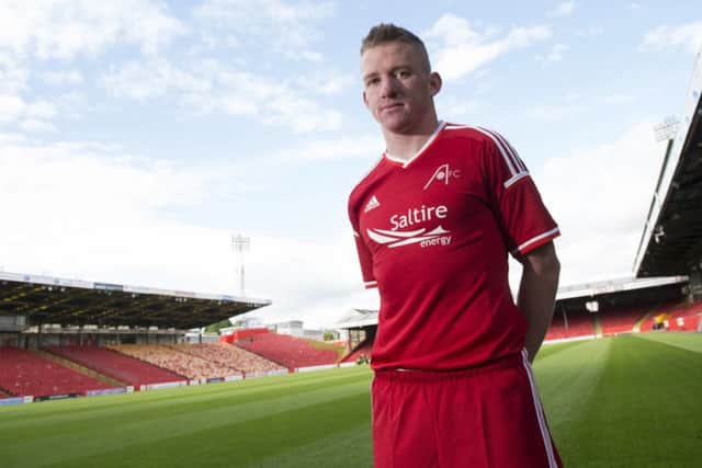 Jonny Hayes shows off the new home kit at Pittodrie. Picture: SNS