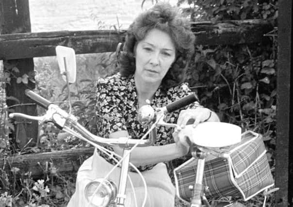 Mrs Shelia Cook the remarried mother of Genette Tate, pictured with her missing daughters bicylcle. Picture: PA