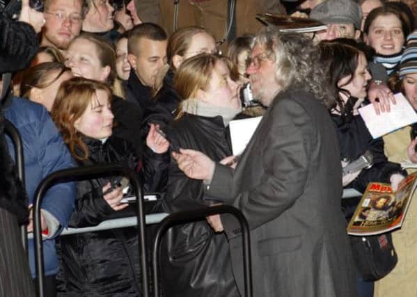 Barrie Osborne signing autographs at a premiere, the producer is hoping to film his new film in Scotland. Picture: AP