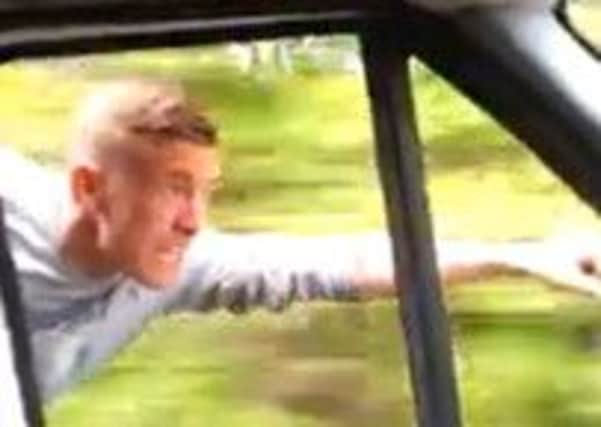 Kevin Hannaway, 24, 'flies' beside the van as it travels down a country road. Picture: YouTube