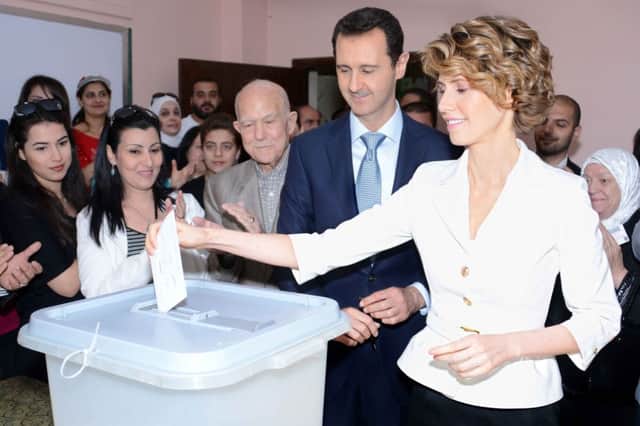 Syrian president Bashar al-Assad and British-born wife Asma vote in the presidential elections. Picture: Getty