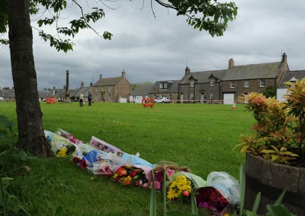 Floral tributes on Swinton village green following the death of three spectators during the Jim Clark Rally. Picture: TSPL