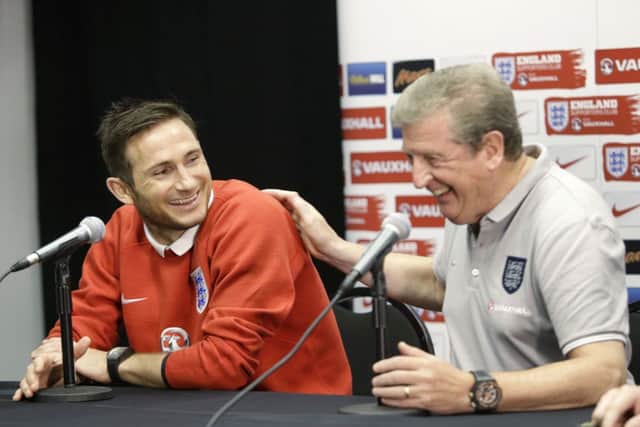 Frank Lampard jokes with manager Roy Hodgson at a press conference. Picture: AP