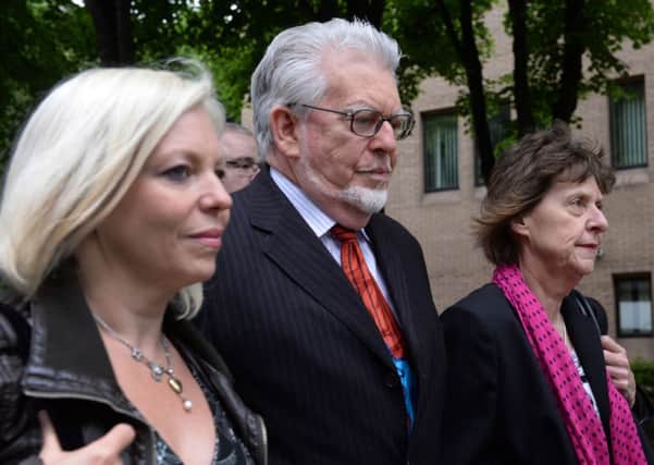 Rolf Harris arrives at court with daughter Bindi, left, and niece Jenny, right. Picture: PA