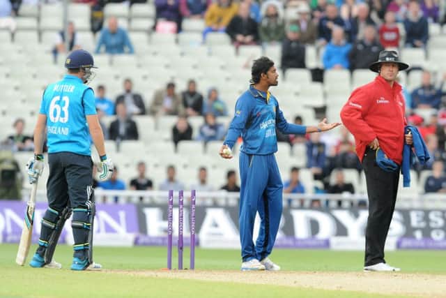 Sachithra Senanayake, centre, appeals to umpire Michael Gough for the  run out of Jos Buttler. Picture: AP