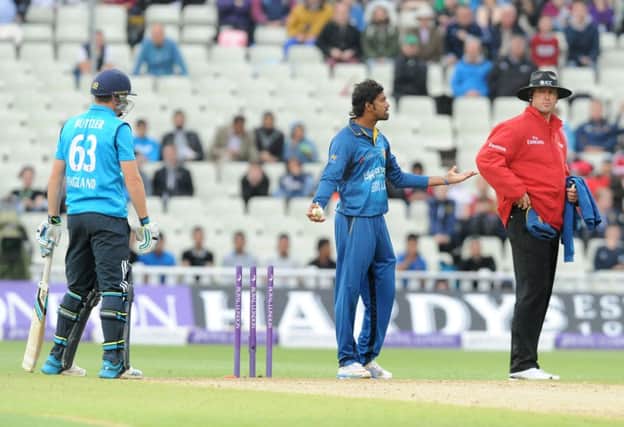 Sachithra Senanayake, centre, appeals to umpire Michael Gough for the  run out of Jos Buttler. Picture: AP
