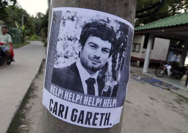 A poster of missing British man Gareth Huntley, 34, is seen at Juara village on Tioman Island. Picture: Reuters