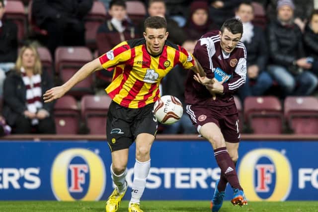 Aaron Taylor-Sinclair pictured in action against Hearts' David Smith. Picture: Ian Georgeson