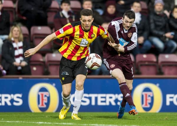 Aaron Taylor-Sinclair pictured in action against Hearts' David Smith. Picture: Ian Georgeson