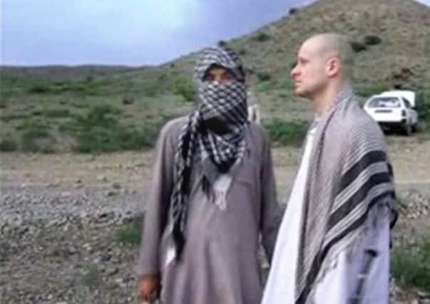 Sergeant Bowe Bergdahl stands with a Taleban fighter in an image taken from the video. Picture: AP