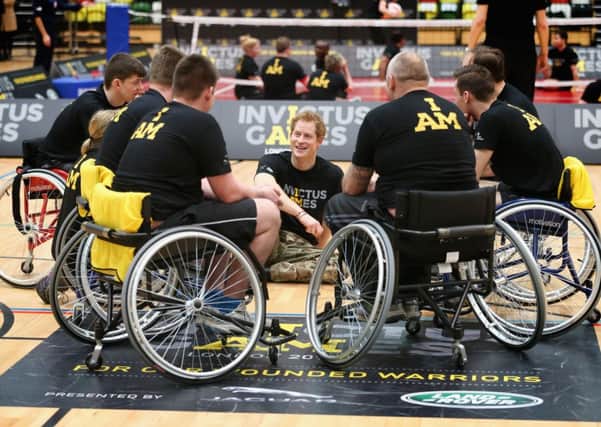 Prince Harry chats to wheelchair basketball players at the launch for the Invictus Games. Picture: Getty