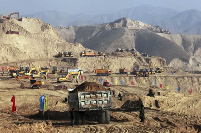 Earth-moving vehicles transform the landscape in Lanzhou, in Gansu province, in north-west China. Picture: AP