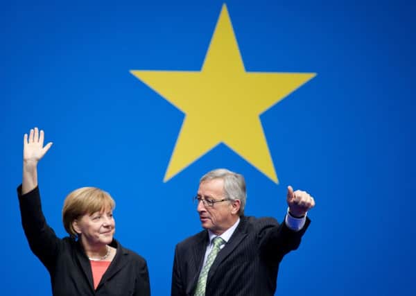 German chancellor Angela Merkel with Commission president candidate Jean-Claude Juncker. Picture: AP
