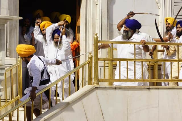 Sikhs clash with guards of the Sikhs' holiest shrine, the Golden Temple, in Amritsar, India. Picture: AP