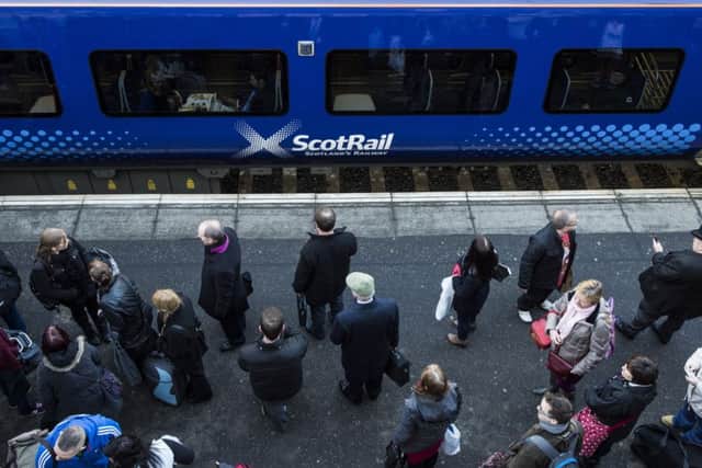 Commuters wait to board a ScotRail train. Picture: Ian Georgeson