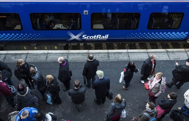 Commuters wait to board a ScotRail train. Picture: Ian Georgeson