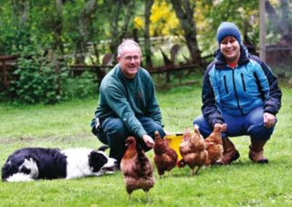 Bob Bull with one of his students, Angus Kyle, feeding chickens at Glachbeg croft. Picture: Peter Jolly