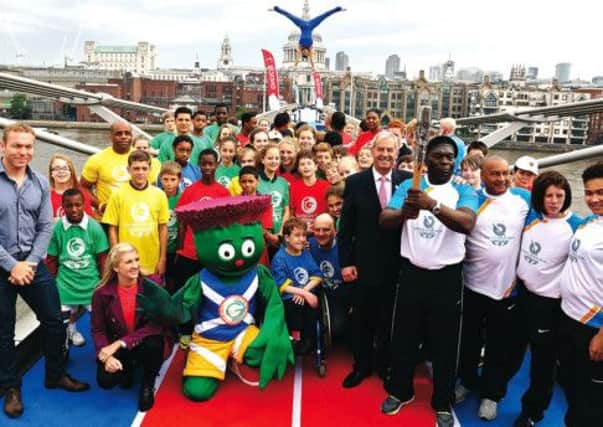Sir Chris Hoy and Rebecca Adlington join the Queens Baton Relay on Londons Millennium Bridge. Picture: Chris Radburn