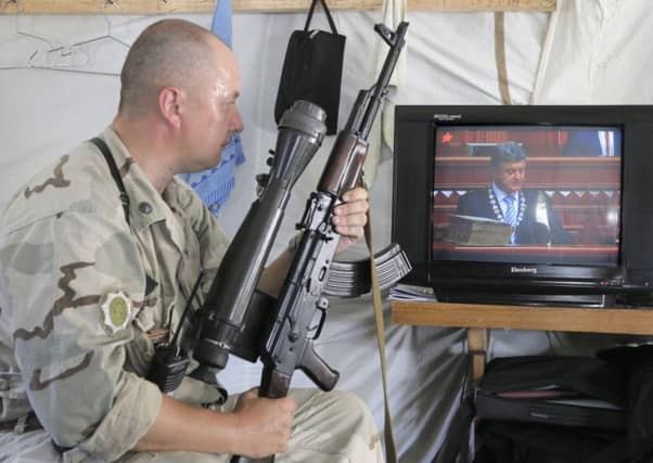 A Ukrainian soldier watches the swearing-in of new president Petro Poroshenko in Kiev. Picture: Efrem Lukatsky