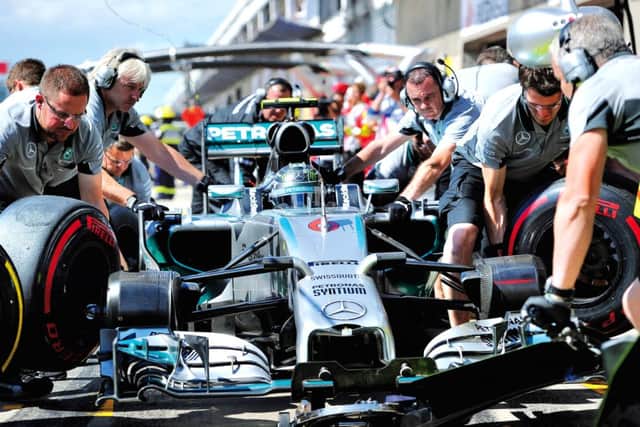 Mercedes driver Nico Rosberg and his team practise a pit stop. Picture: Getty Images