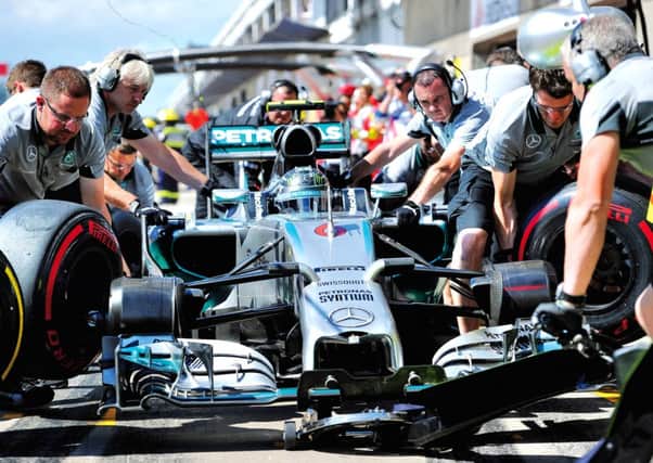 Mercedes driver Nico Rosberg and his team practise a pit stop. Picture: Getty Images