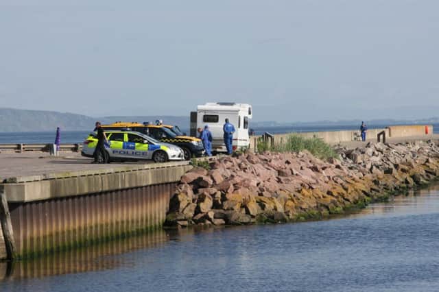 Police teams search the River Nairn. Picture: Peter Jolly