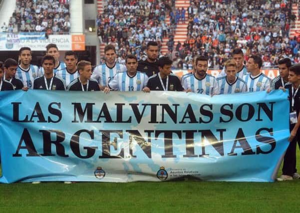 Argentina poses for a picture with a banner reading in Spanish "The Malvinas are Argentine". Picture: AP