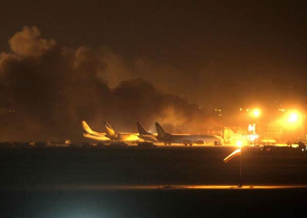 Fire illuminates the night sky above the Jinnah International Airport in Karachi. Picture: AP
