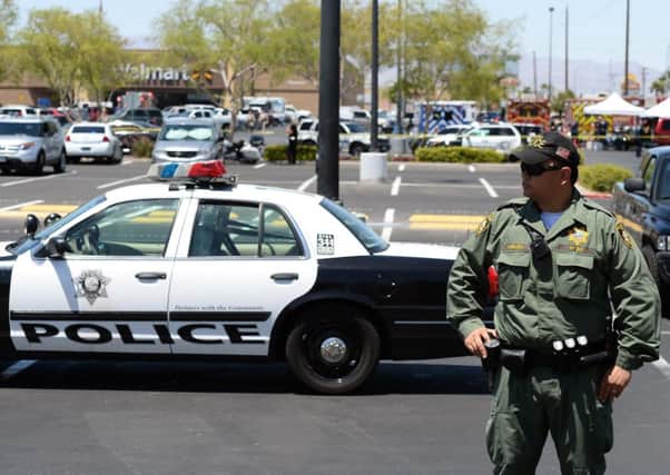 A Las Vegas police officer stands in the car park at the WalMart where the killers died. Picture: Getty Images