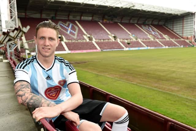 Hearts ace Jordan McGhee unveils the club's new away kit for the 2014/2015 season. Picture: SNS