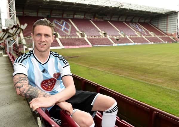 Hearts ace Jordan McGhee unveils the club's new away kit for the 2014/2015 season. Picture: SNS