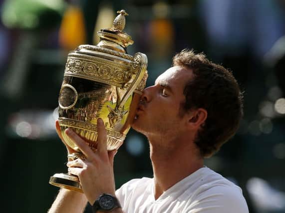 Andy Murray celebrates with the trophy after winning Wimbledon last year. Picture: PA