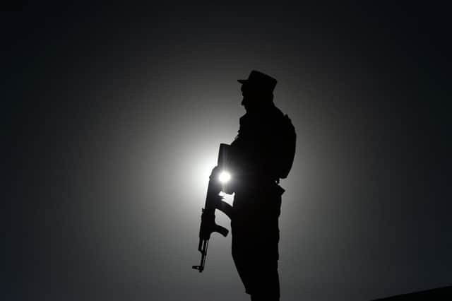 An Afghan policeman keeps watch during an election campaign rally in the Paghman district of Kabul province. Picture: AFP/ Getty