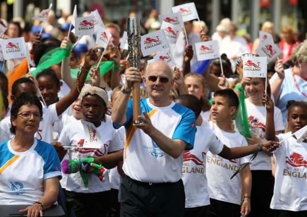 Batonbearer Trevor Low holding the Queen's Baton in Leicester, England before it arrives in Scotland on Saturday. Picture: Getty